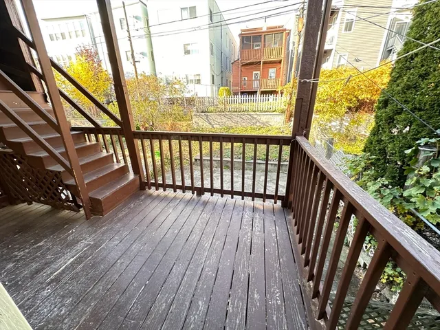a view of balcony with wooden floor
