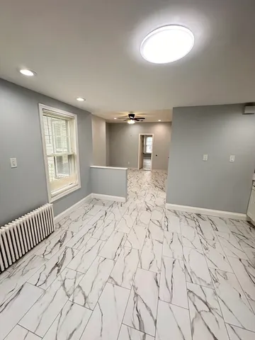 a view of a bedroom with a bed and a window