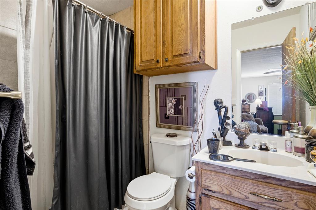 1507 McFerrin Avenue, Unit 9 Waco, TX 76708 - Photo 17 of 26 a white toilet sitting next to a bathroom sink