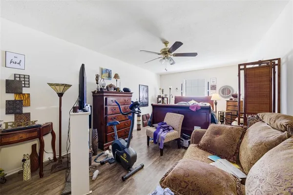 a living room with furniture a air conditioner and a window