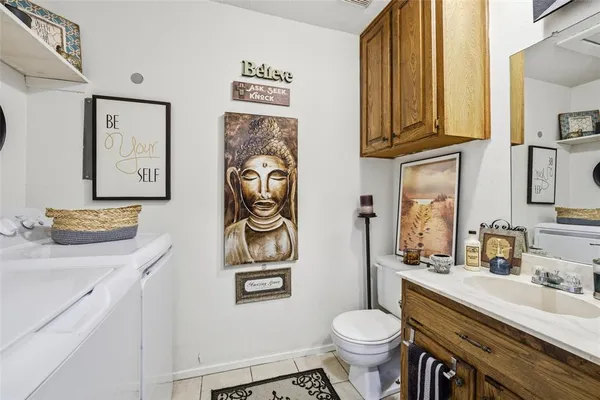 a bathroom with a toilet sink and mirror