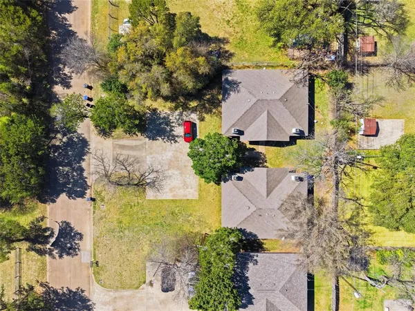 an aerial view of a house with a yard