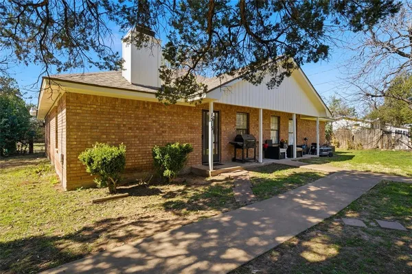 a view of a house with backyard porch and sitting area