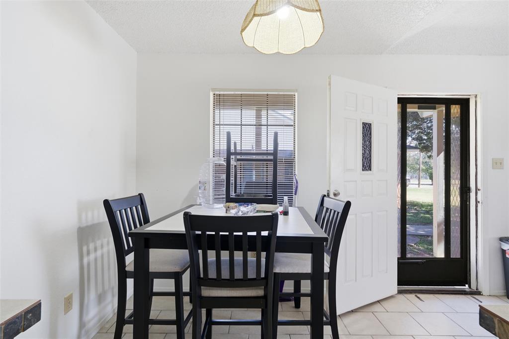 1507 McFerrin Avenue, Unit 9 Waco, TX 76708 - Photo 10 of 26 a view of a dining room with furniture wooden floor and chandelier