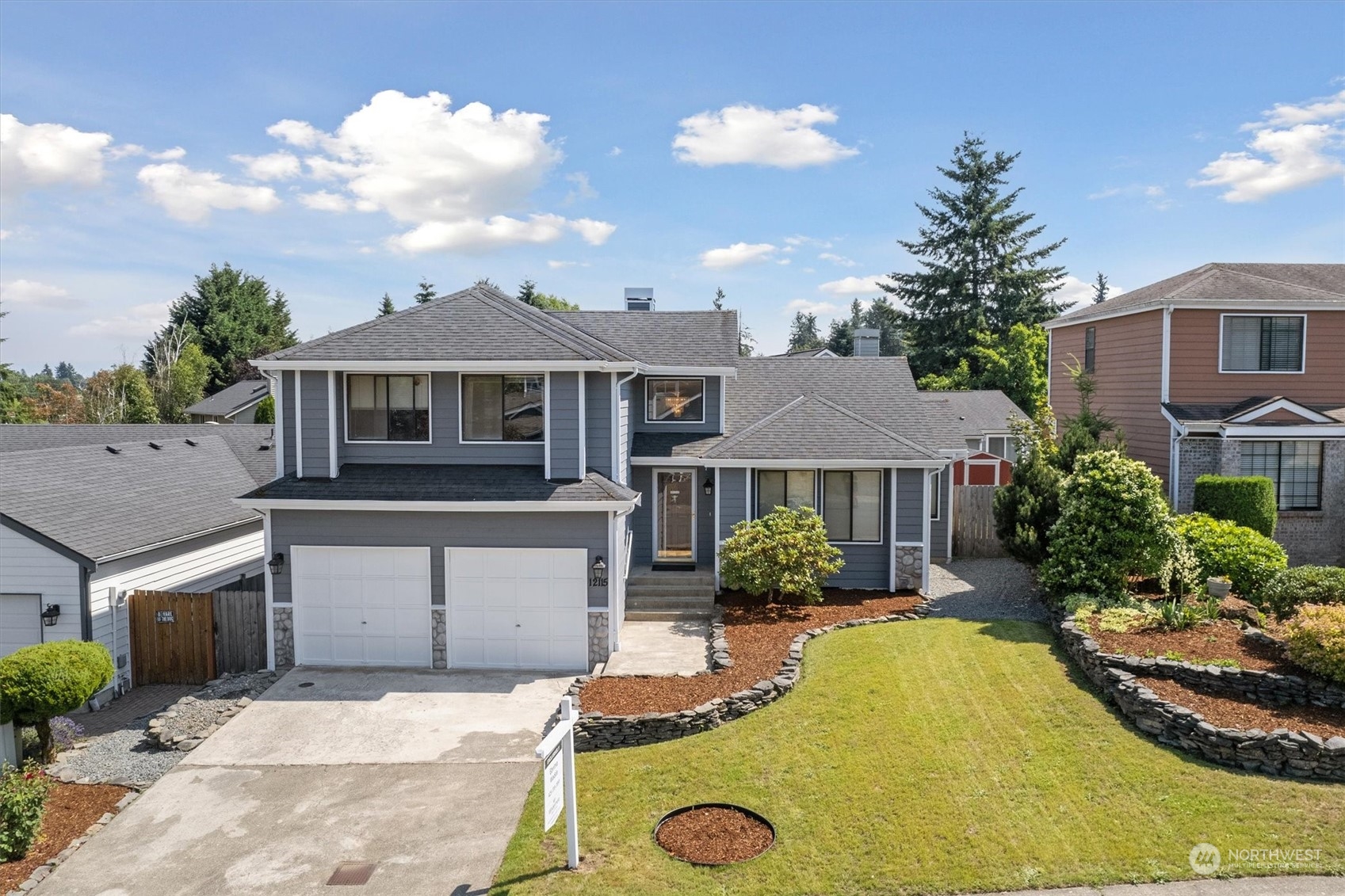 12115 Southeast 280th Street Kent, WA 98030 - Photo 1 of 40 a view of a house with a garden and plants