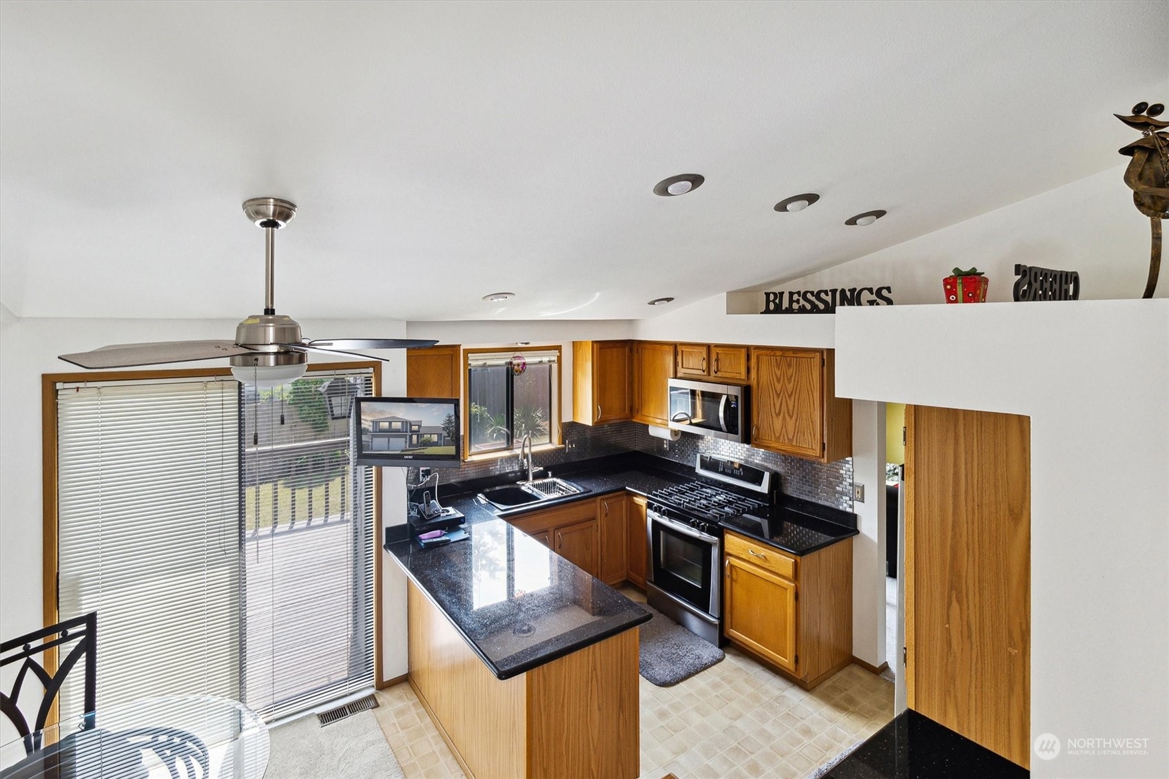 12115 Southeast 280th Street Kent, WA 98030 - Photo 12 of 40 a kitchen that has a stove and a refrigerator