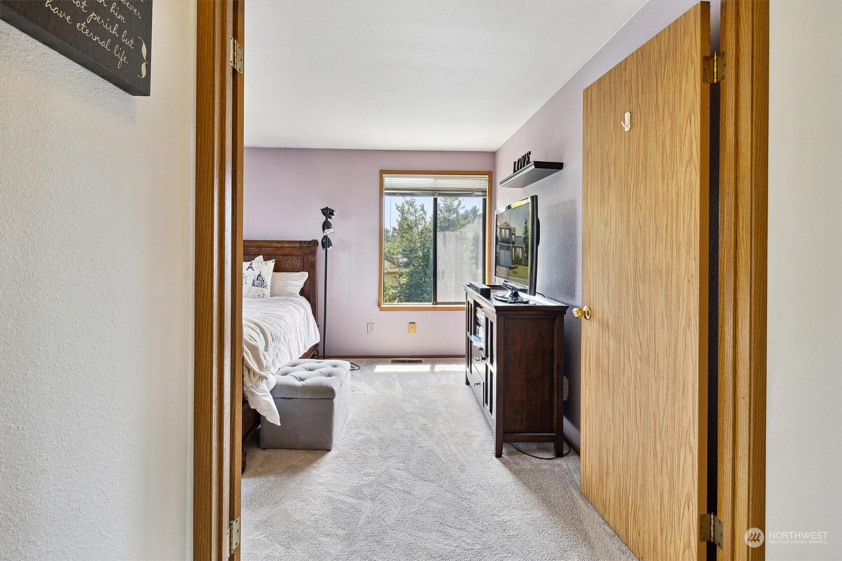 12115 Southeast 280th Street Kent, WA 98030 - Photo 21 of 40 a view of a bedroom with a bed and wooden floor
