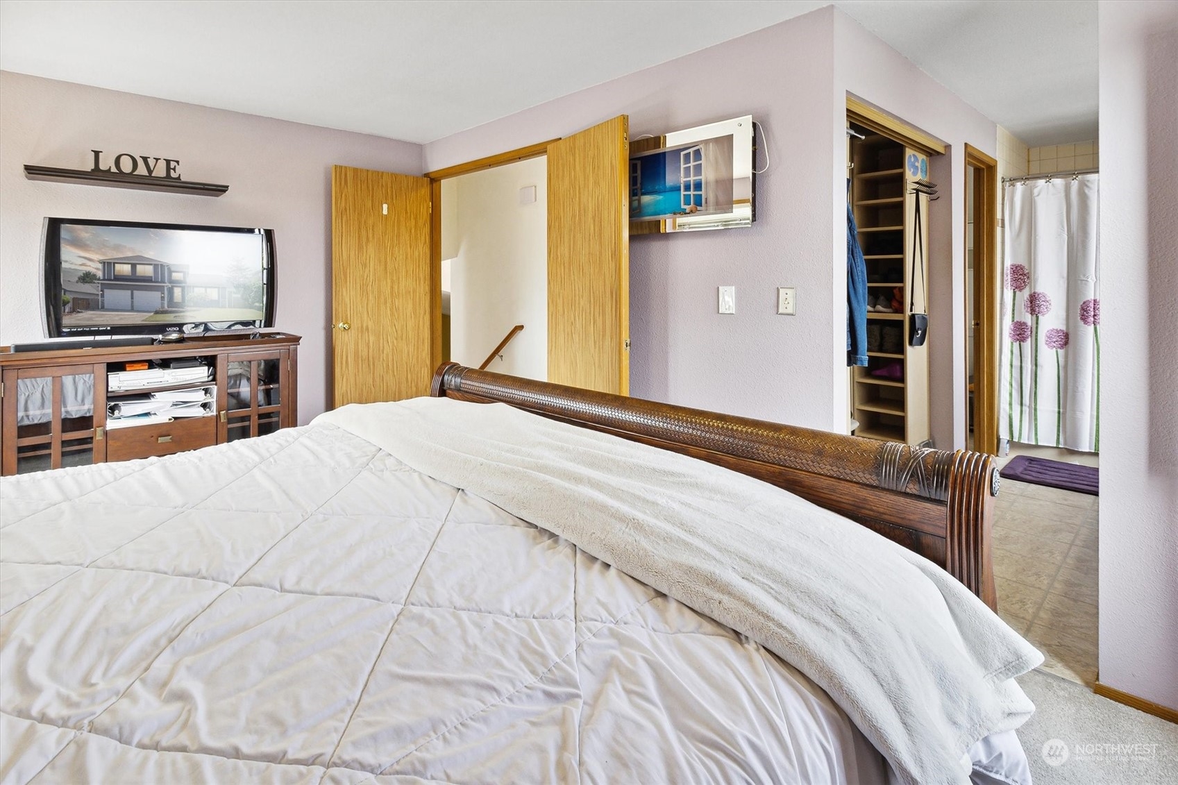 12115 Southeast 280th Street Kent, WA 98030 - Photo 25 of 40 a bedroom with a bed and a flat screen tv