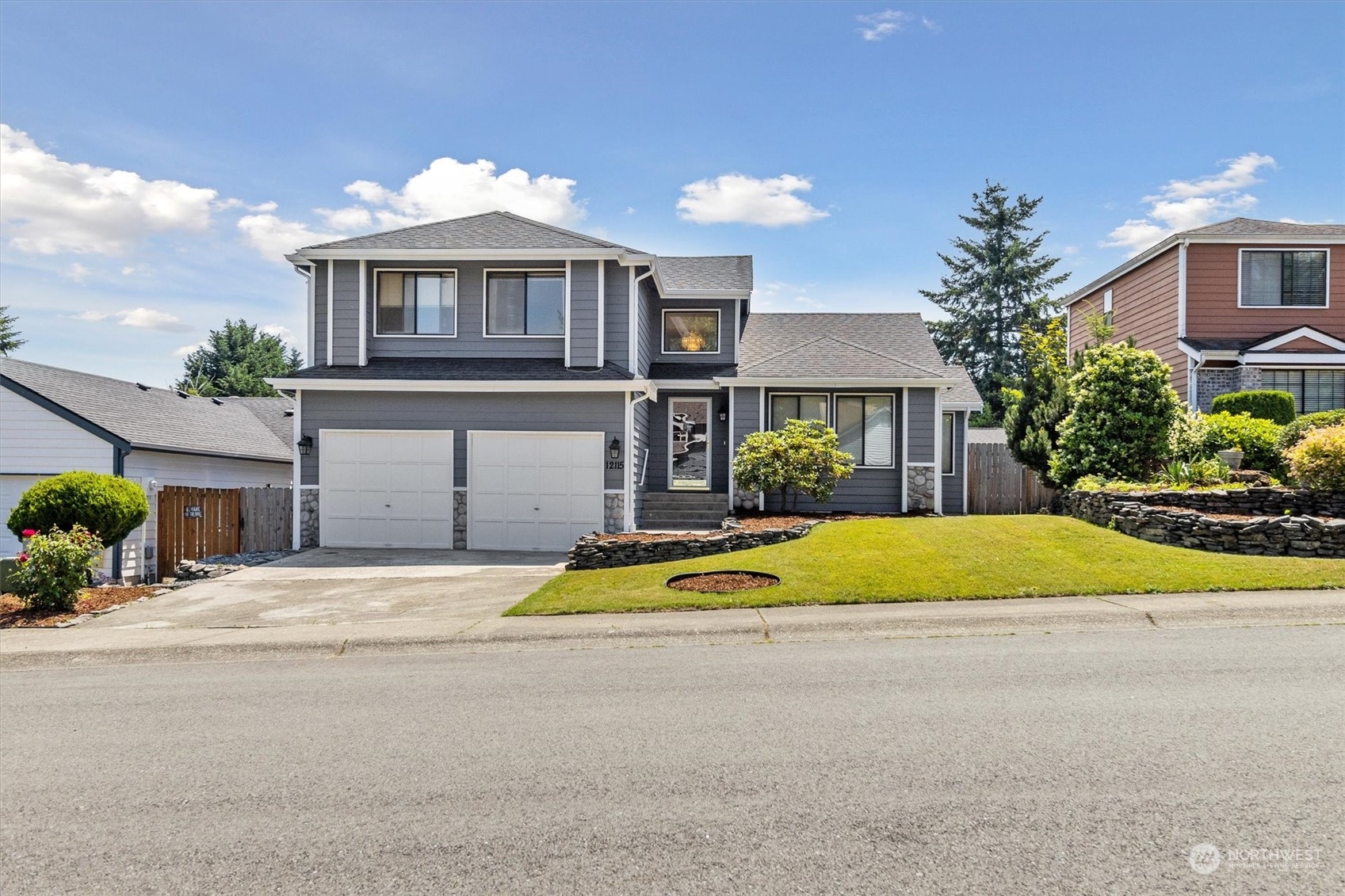 12115 Southeast 280th Street Kent, WA 98030 - Photo 27 of 40 a front view of a house with a yard and potted plants