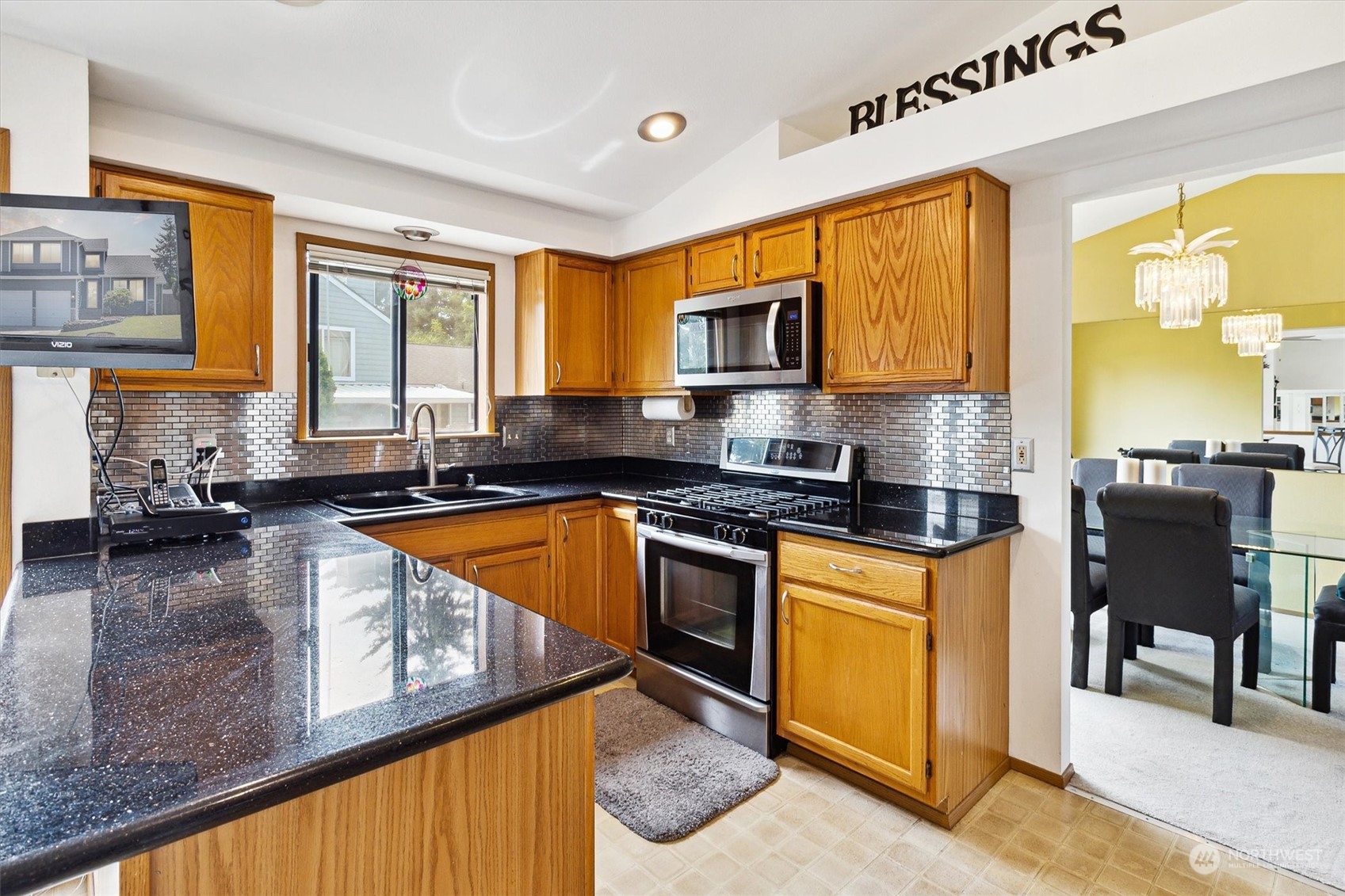 12115 Southeast 280th Street Kent, WA 98030 - Photo 10 of 40 a kitchen with stainless steel appliances granite countertop a stove a sink and a microwave