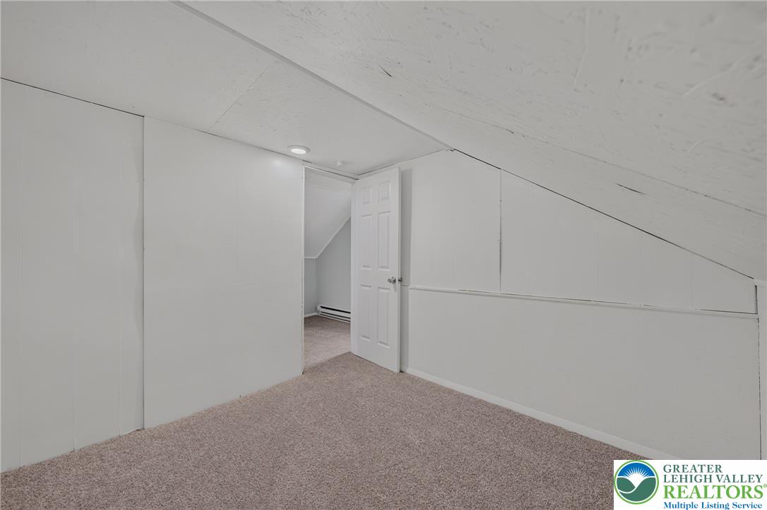 313 Main Street Slatington, PA 18080 - Photo 61 of 73 A cozy, sloped-ceiling room with soft carpet provides a comfortable retreat.