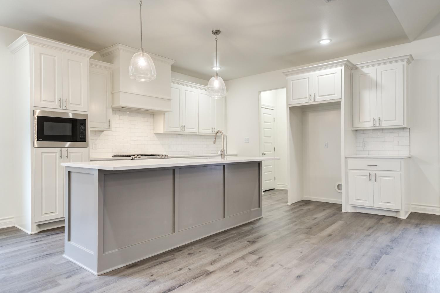 3712 144th Street Lubbock, TX 79423 - Photo 11 of 46 a kitchen with kitchen island a sink stainless steel appliances and cabinets