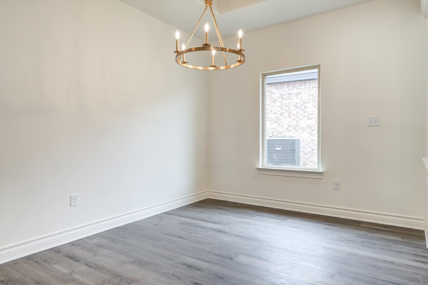 3712 144th Street Lubbock, TX 79423 - Photo 18 of 46 an empty room with wooden floor and windows