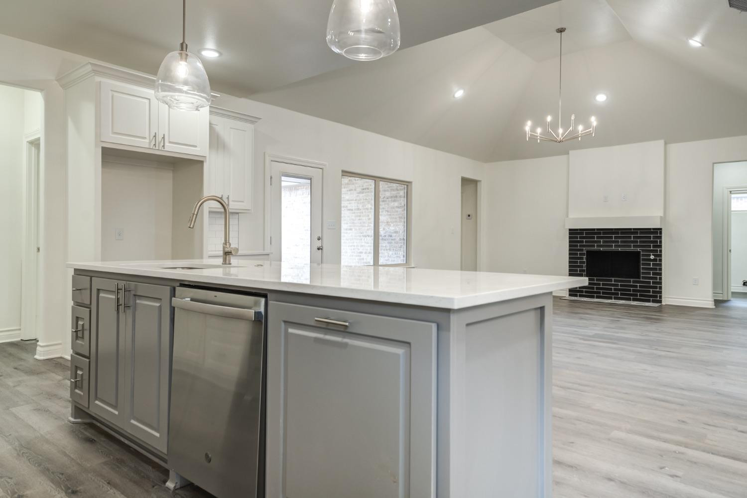 3712 144th Street Lubbock, TX 79423 - Photo 21 of 46 a kitchen with kitchen island a sink stainless steel appliances and cabinets
