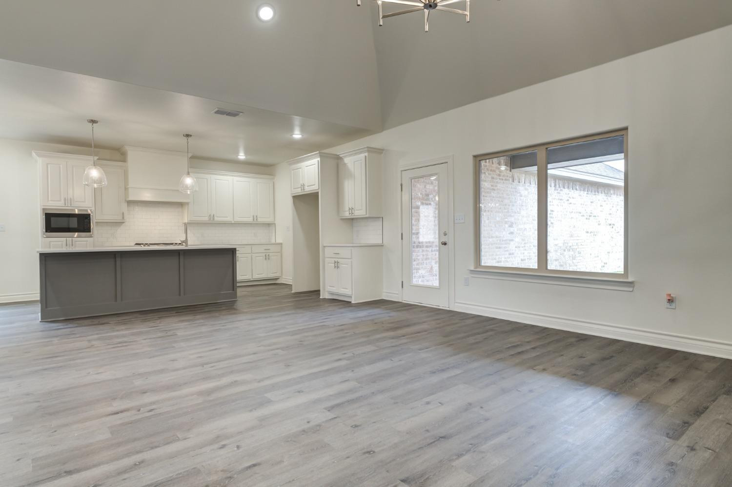 3712 144th Street Lubbock, TX 79423 - Photo 26 of 46 an empty room with wooden floor and windows