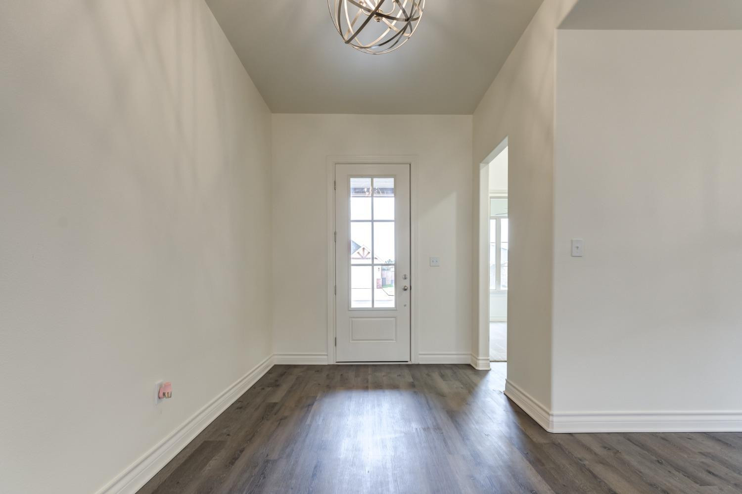 3712 144th Street Lubbock, TX 79423 - Photo 3 of 46 an empty room with wooden floor and window