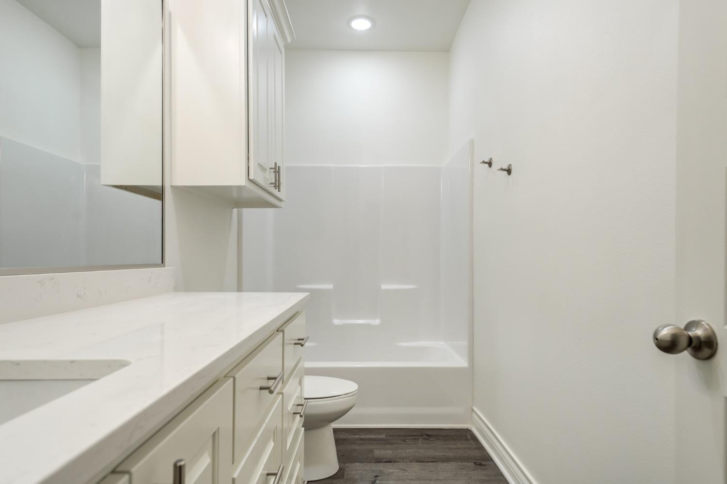 3712 144th Street Lubbock, TX 79423 - Photo 34 of 46 a bathroom with a sink a toilet and shower