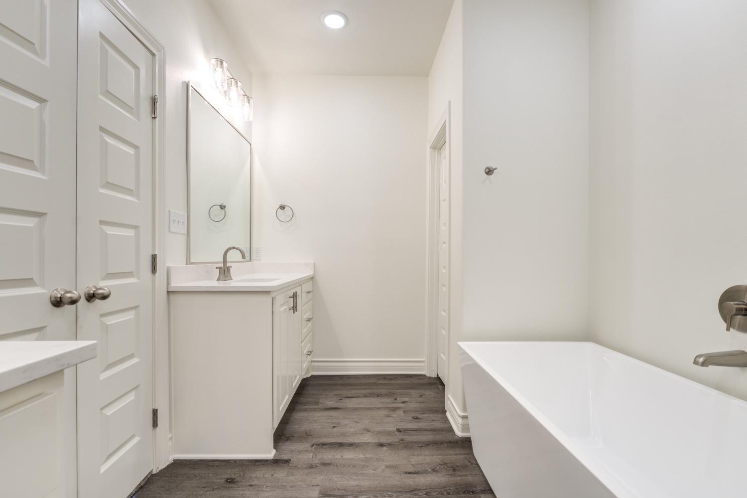 3712 144th Street Lubbock, TX 79423 - Photo 40 of 46 a bathroom with a sink a toilet and shower