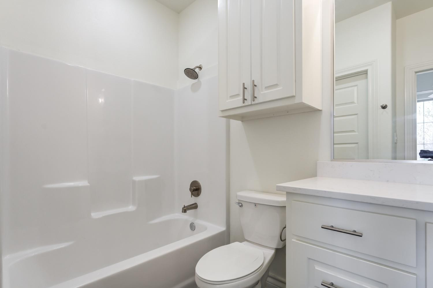3712 144th Street Lubbock, TX 79423 - Photo 8 of 46 a bathroom with a sink a toilet and bathtub