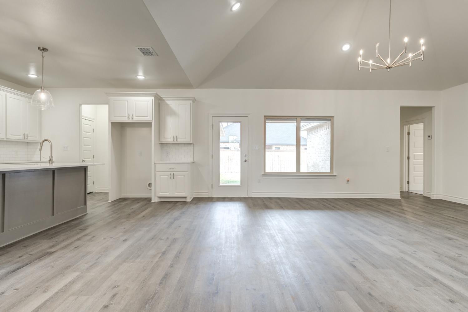 3712 144th Street Lubbock, TX 79423 - Photo 9 of 46 an empty room with wooden floor and windows