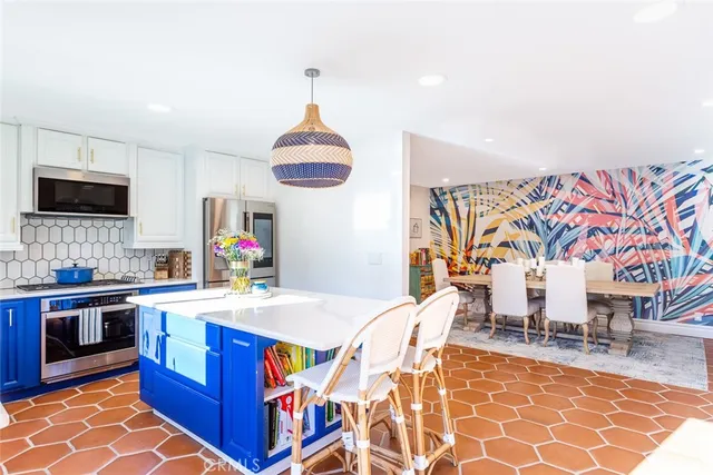 a kitchen with stainless steel appliances granite countertop a sink and a wooden floors