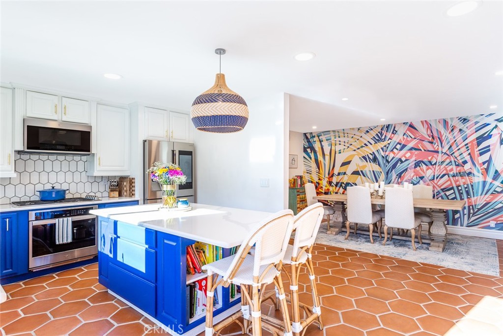 2718 North Wright Street Santa Ana, CA 92705 - Photo 12 of 45 a kitchen with stainless steel appliances granite countertop a sink and a wooden floors