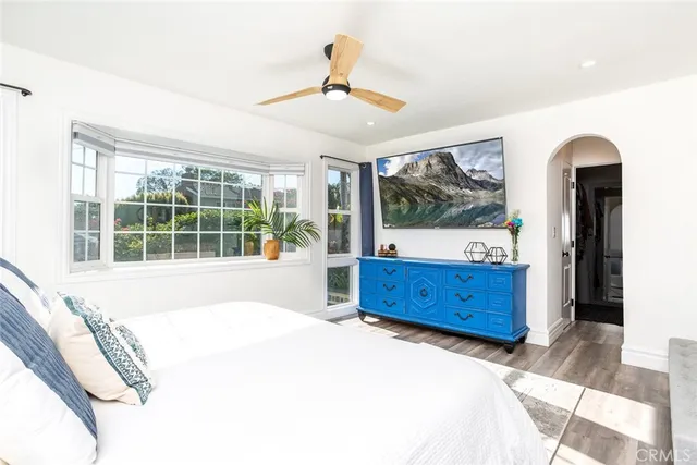 a large bedroom with a large bed and a large window