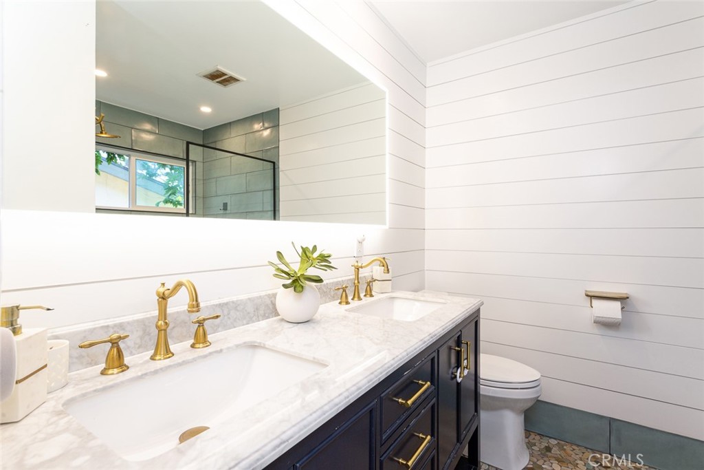 2718 North Wright Street Santa Ana, CA 92705 - Photo 17 of 45 a bathroom with a granite countertop sink a toilet and a mirror