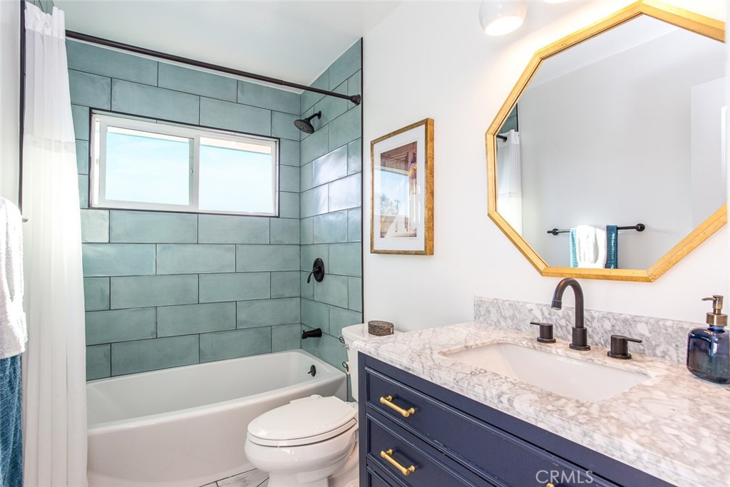 2718 North Wright Street Santa Ana, CA 92705 - Photo 21 of 45 a bathroom with a granite countertop sink toilet mirror and bathtub
