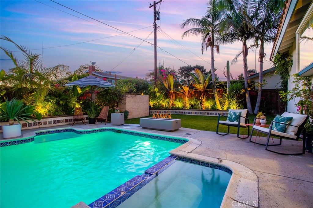 2718 North Wright Street Santa Ana, CA 92705 - Photo 43 of 45 a view of a swimming pool with a table and chairs