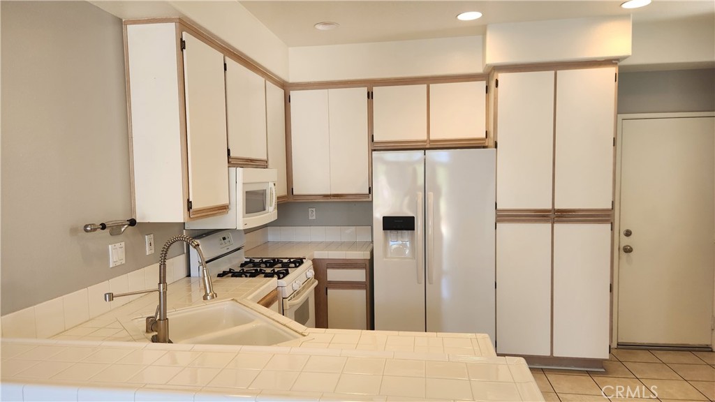 28456 Yosemite Drive Lake Forest, CA 92679 - Photo 3 of 33 a kitchen with stainless steel appliances granite countertop a refrigerator and a sink