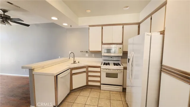 a kitchen with a sink a stove a refrigerator and cabinets