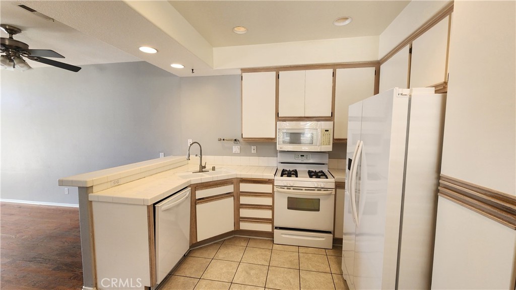 28456 Yosemite Drive Lake Forest, CA 92679 - Photo 4 of 33 a kitchen with a sink a stove a refrigerator and cabinets
