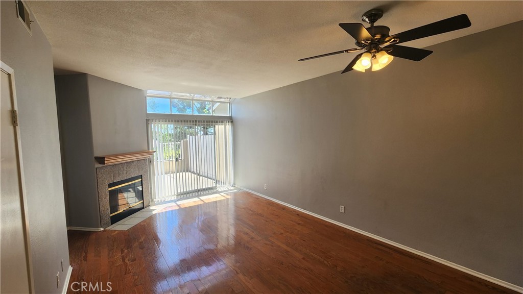 28456 Yosemite Drive Lake Forest, CA 92679 - Photo 6 of 33 an empty room with wooden floor fan and windows
