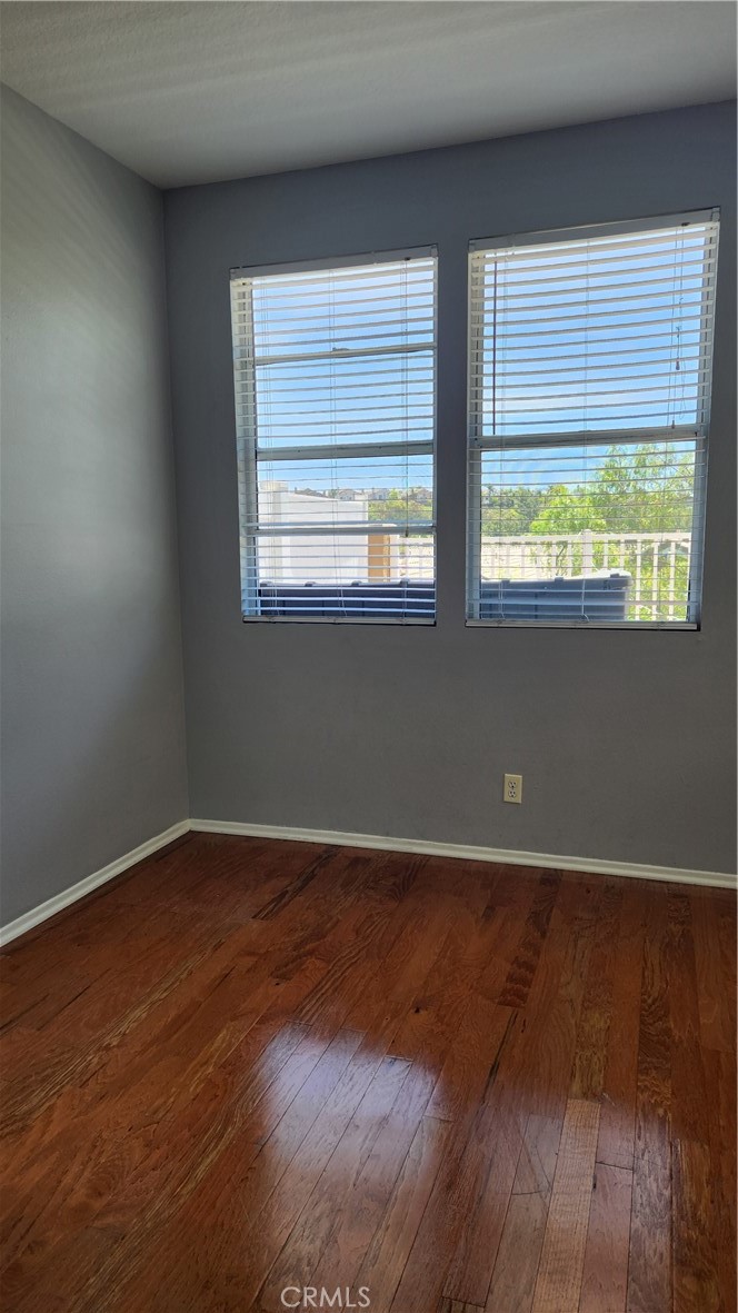 28456 Yosemite Drive Lake Forest, CA 92679 - Photo 8 of 33 an empty room with wooden floor and windows