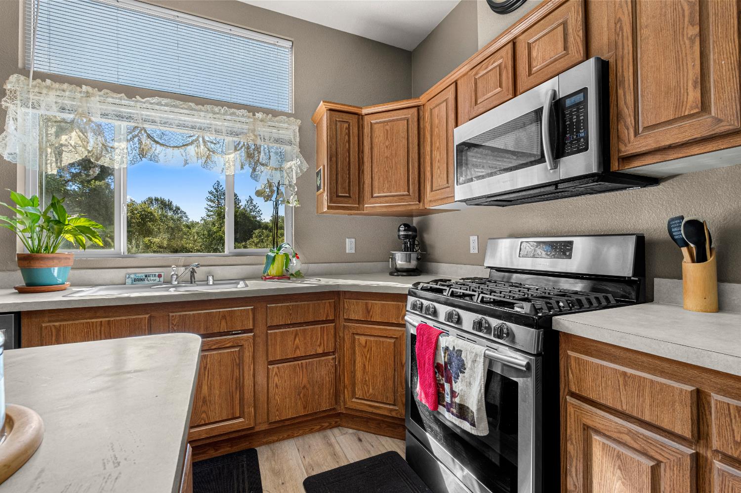 9425 Mosquito Road Placerville, CA 95667 - Photo 29 of 74 a kitchen with stainless steel appliances granite countertop a stove a sink and a microwave