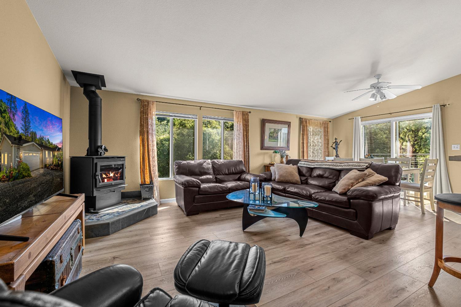 9425 Mosquito Road Placerville, CA 95667 - Photo 32 of 74 a living room with furniture flat screen tv and a fireplace