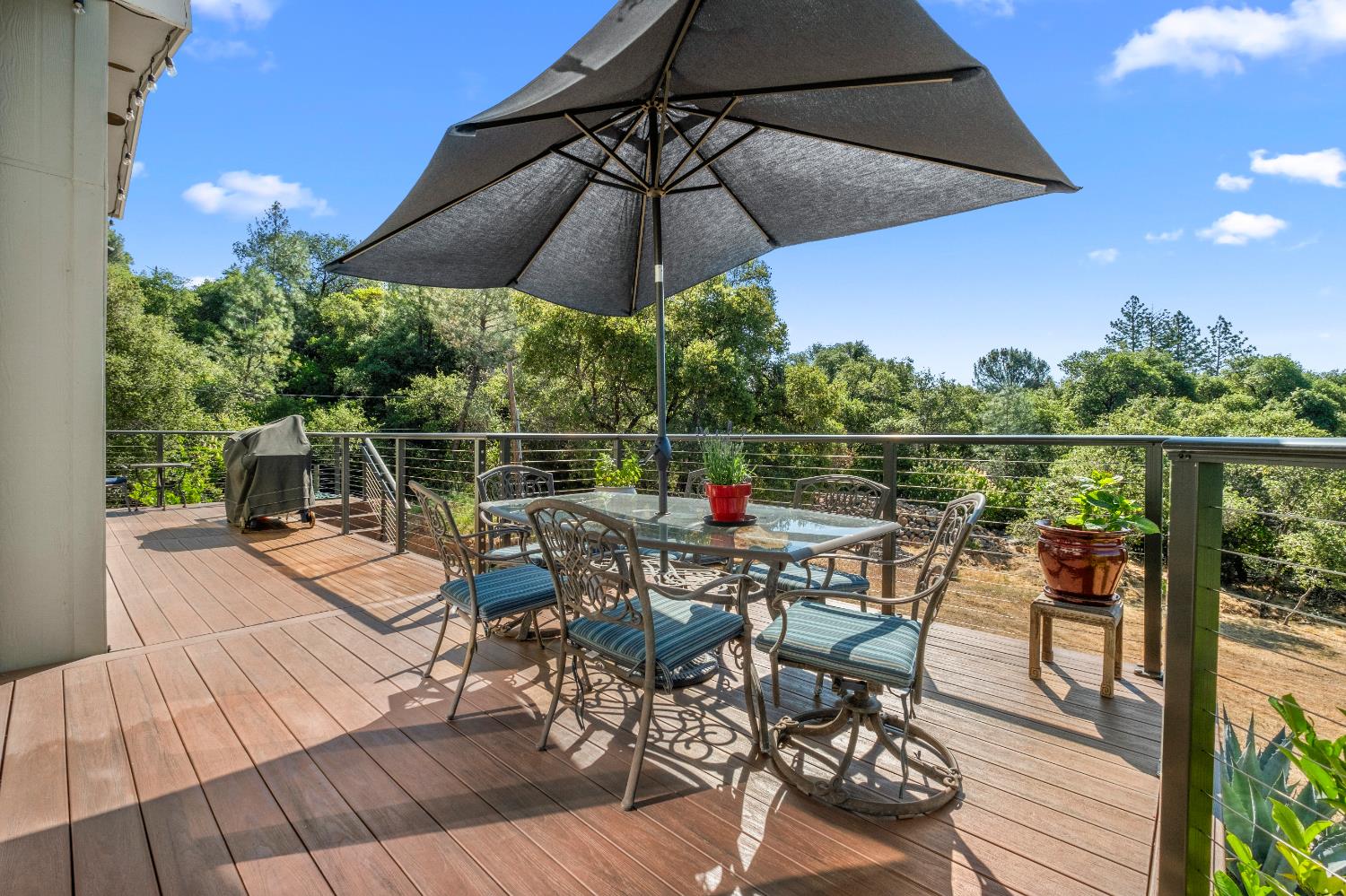 9425 Mosquito Road Placerville, CA 95667 - Photo 45 of 74 a view of a roof deck with table and chairs under an umbrella