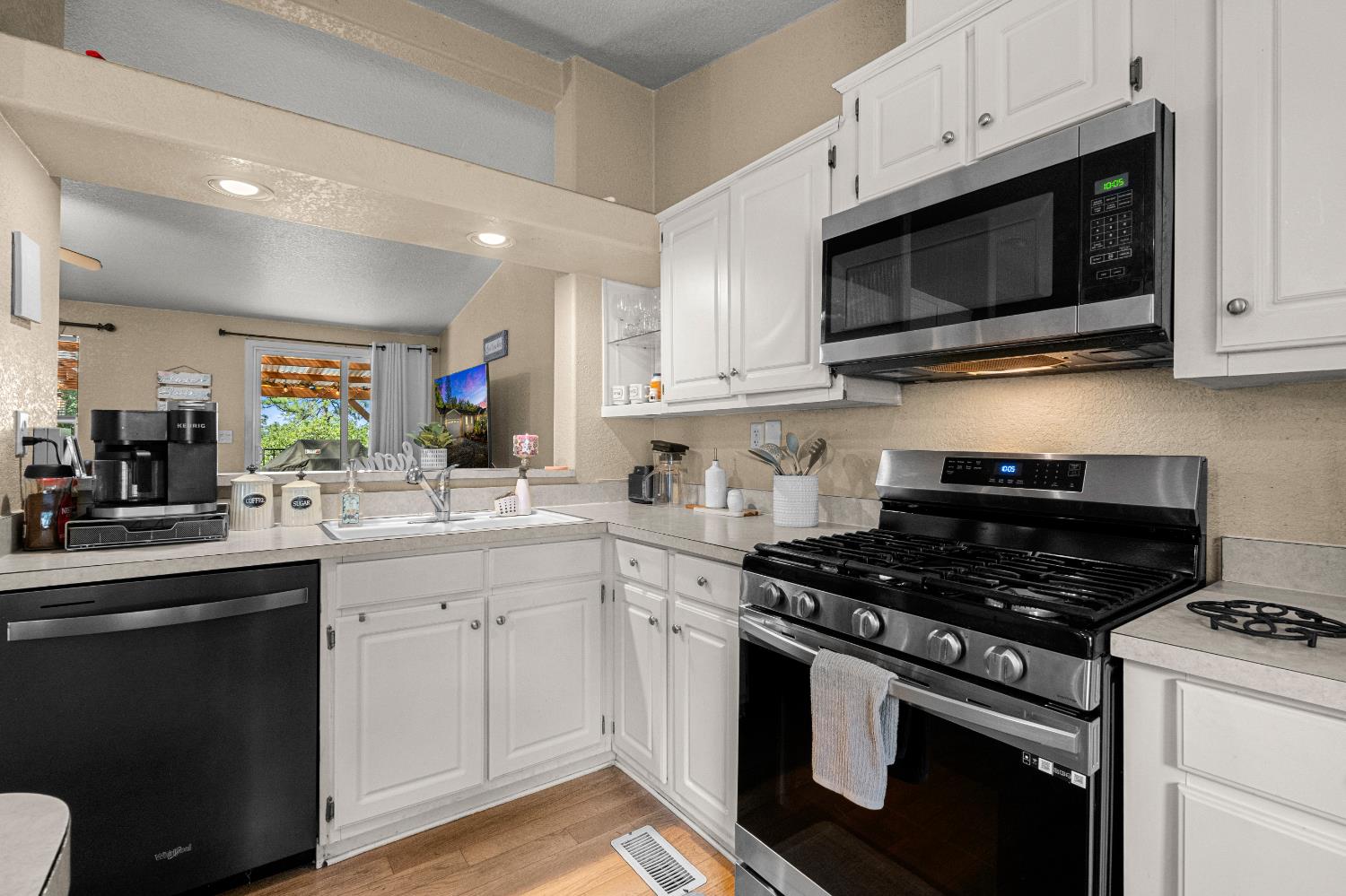 9425 Mosquito Road Placerville, CA 95667 - Photo 56 of 74 a kitchen with stainless steel appliances granite countertop grey cabinets a stove a sink and a microwave