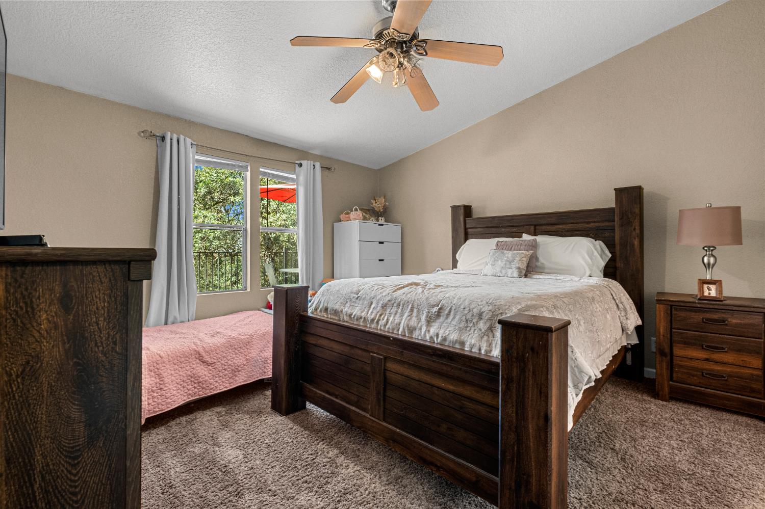 9425 Mosquito Road Placerville, CA 95667 - Photo 61 of 74 a bedroom with a large bed and a chandelier