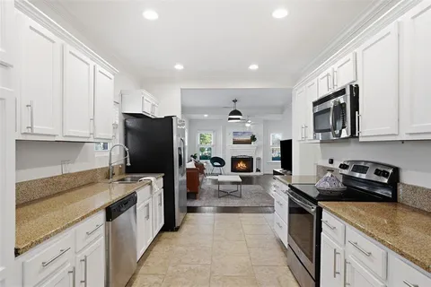 a kitchen with stainless steel appliances granite countertop a refrigerator stove microwave and sink