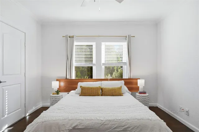 a bedroom with bed and wooden floor