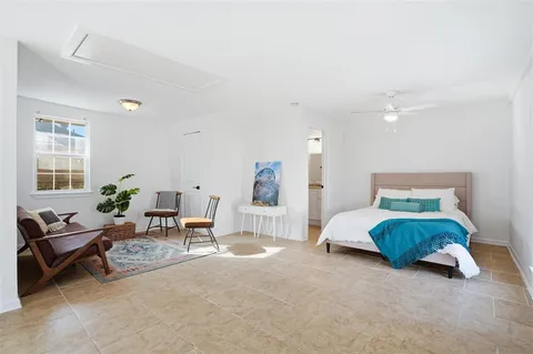 a spacious bedroom with a bed and a couch