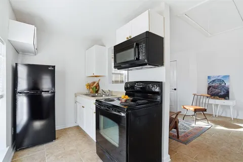 a kitchen with a stove and a refrigerator