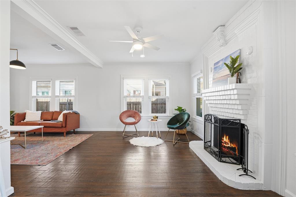 1102 Brunner Avenue Dallas, TX 75224 - Photo 6 of 38 a view of a livingroom with furniture wooden floor fireplace and windows