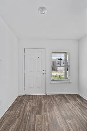 an empty room with windows and closet