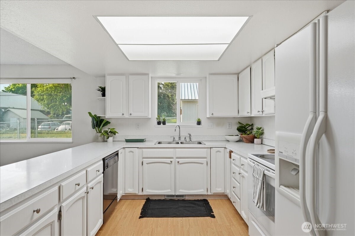 309 West Walnut Street Waterville, WA 98858 - Photo 7 of 28 a kitchen with white cabinets and white appliances