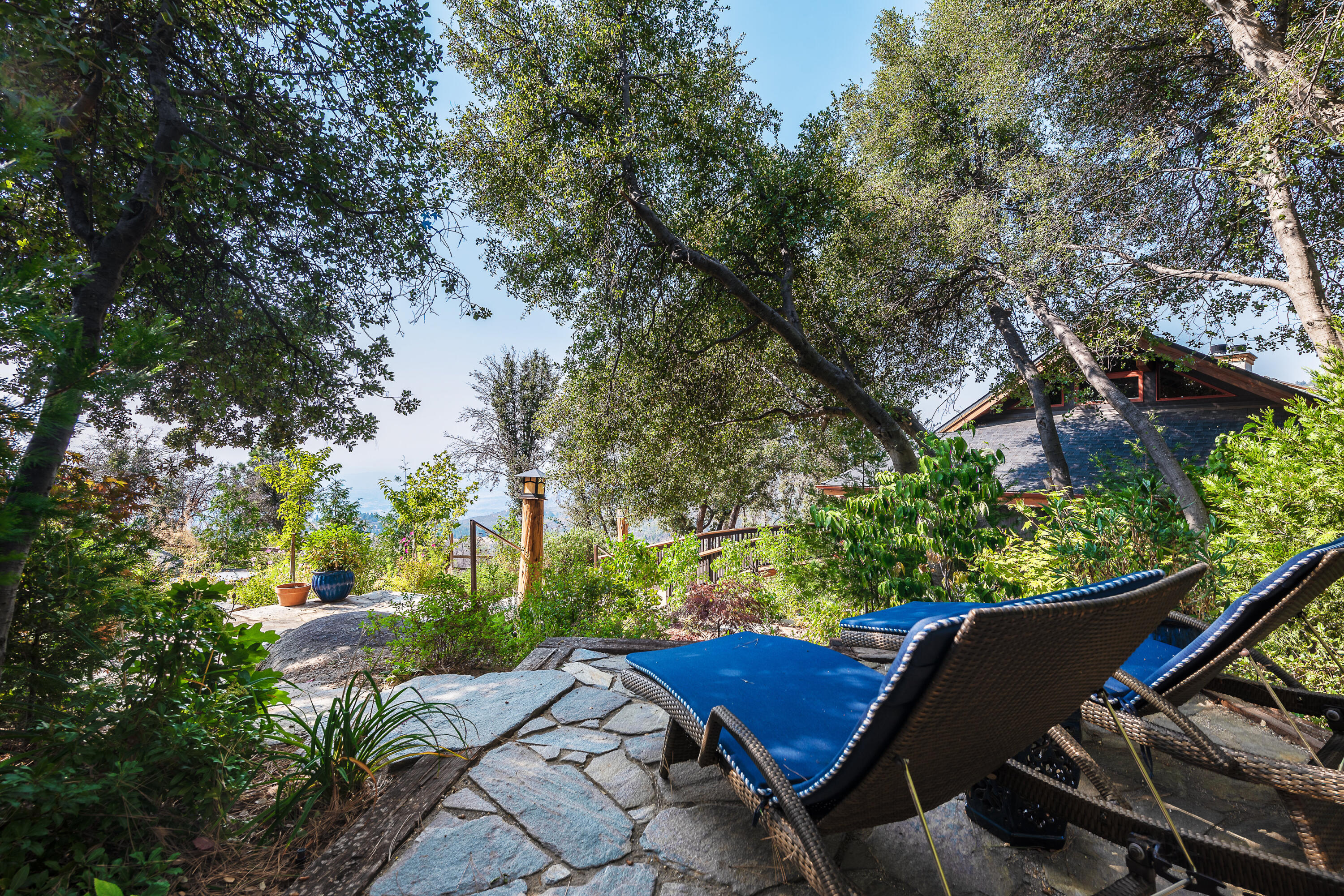 52430 Double View Drive Idyllwild, CA 92549 - Photo 30 of 74 a view of a patio with table and chairs under an umbrella