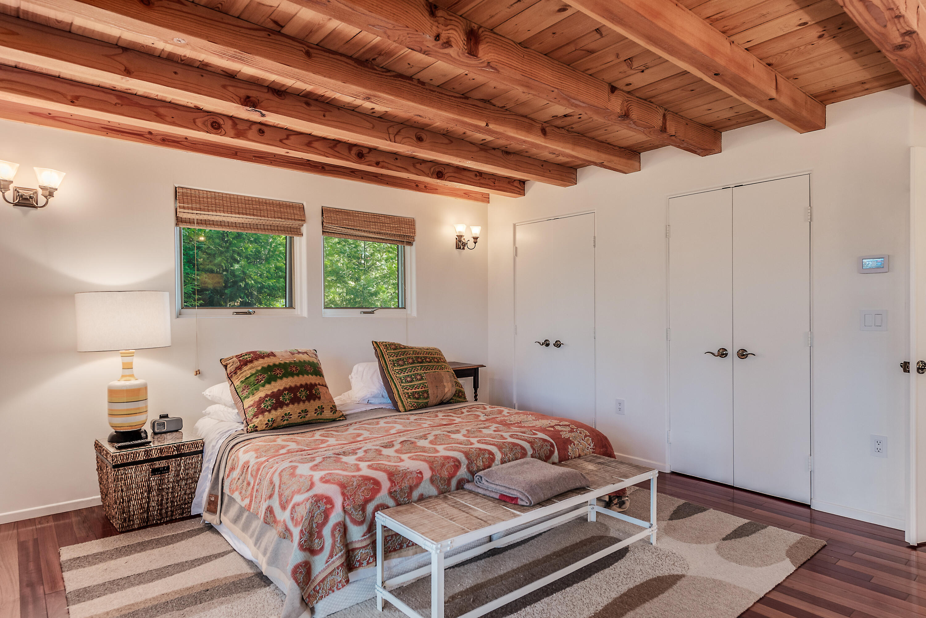 52430 Double View Drive Idyllwild, CA 92549 - Photo 56 of 74 a bedroom with a large bed and a lamp on dresser