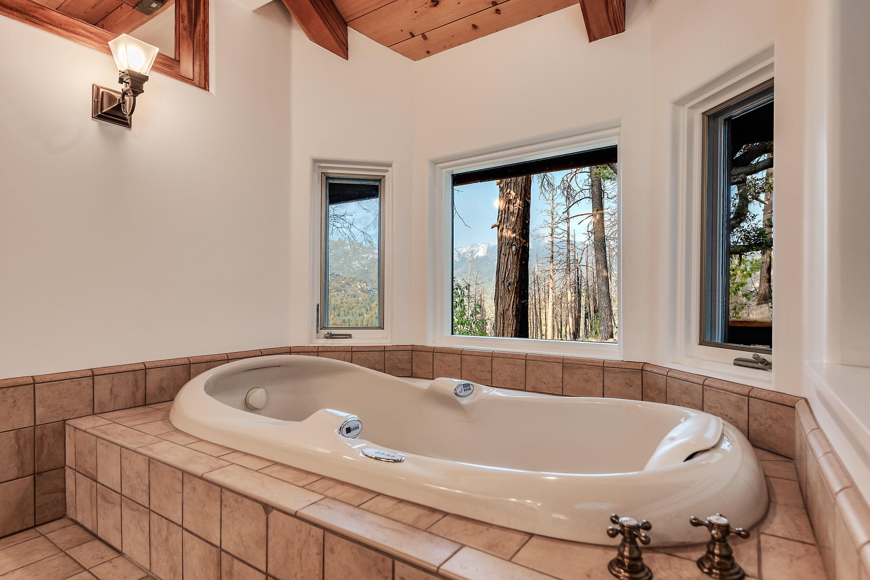 52430 Double View Drive Idyllwild, CA 92549 - Photo 59 of 74 a white bath tub sitting in a bathroom next to a window